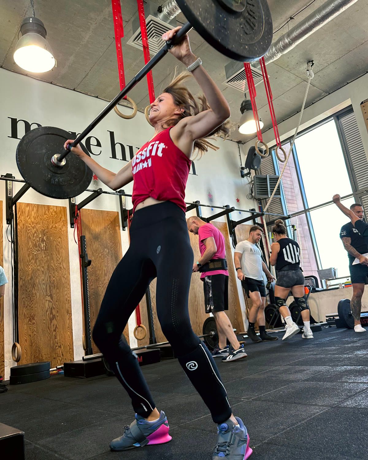 Osoba w boksie CrossFit Wilanów podczas rwania ze sztangą nad głową
